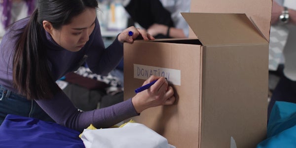 Person marking box as a donation