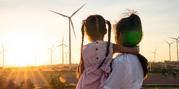 Parent and child looking off into sunset